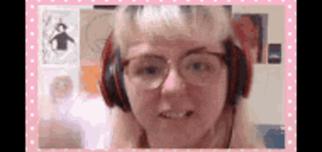 a woman wearing headphones and glasses is looking at the camera .