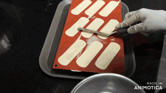 a person is using a spatula on a silicone mat that says made in animonica