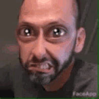 a close up of a man with a beard making a funny face .