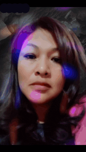 a close up of a woman 's face with purple highlights