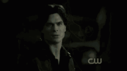 a couple standing in front of a house with the cw logo