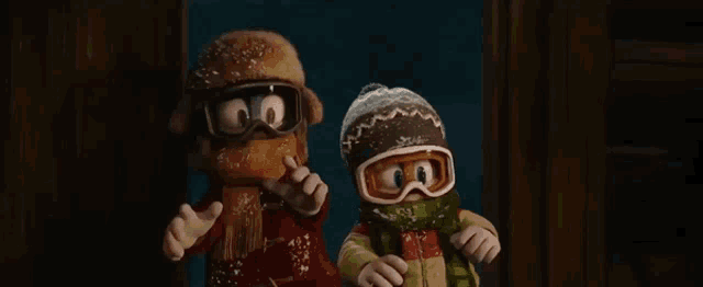 two cartoon characters wearing hats and scarves are standing next to each other in a doorway .
