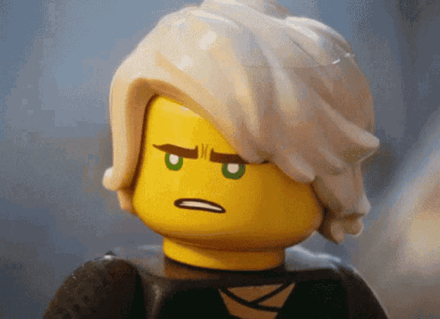 a close up of a lego figure with a serious expression on his face