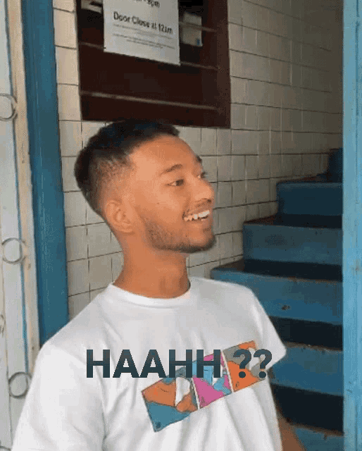 a man wearing a white shirt with the word haah on it