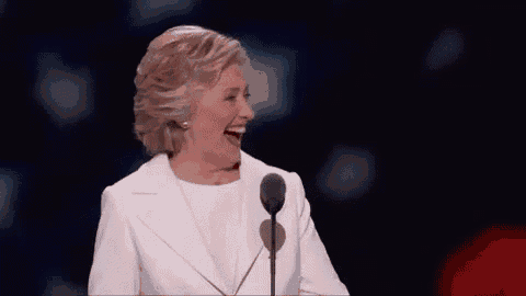 hillary clinton is laughing while giving a speech at a convention .