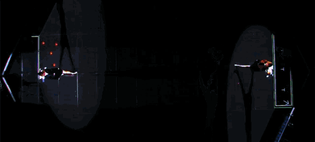 two people are dancing in front of a screen that says ' aerial ' on it