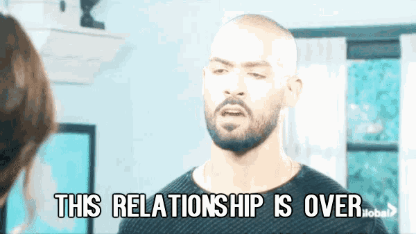 a man with a beard is talking to a woman and says this relationship is over