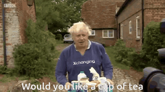 a man wearing a blue shirt that says " xchanging " on it