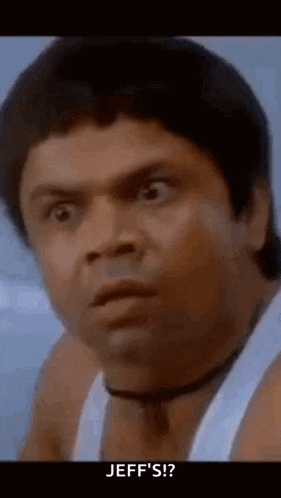 a man in a white tank top is making a funny face and saying `` jeff 's '' .