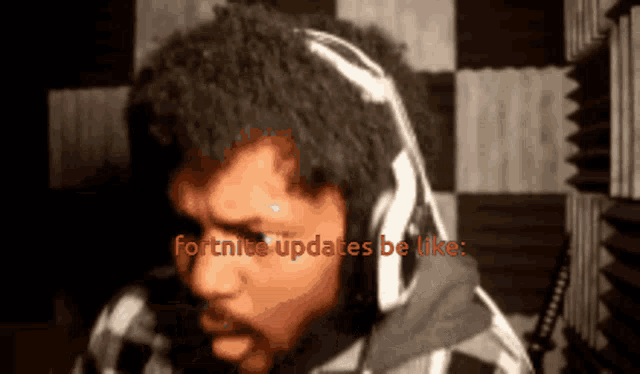 a man wearing headphones with the words fortnite updates be like on the bottom