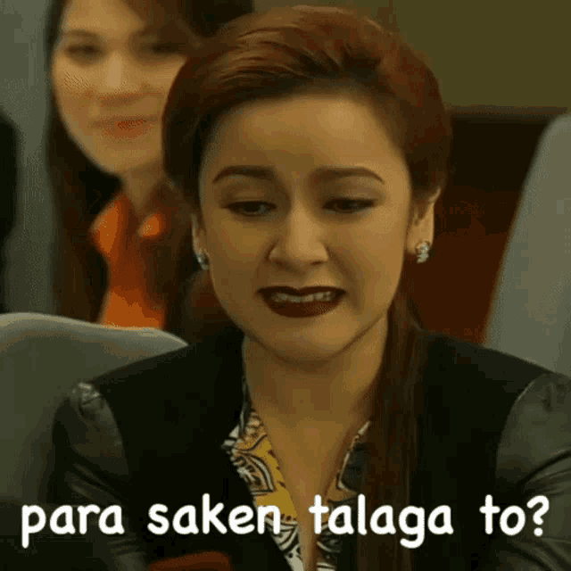 a woman is sitting in front of a sign that says parasaken talaga to?
