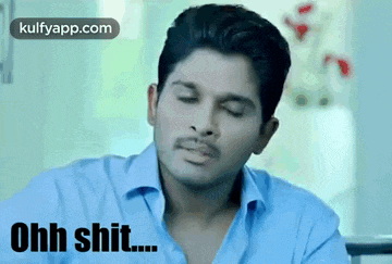 a man in a blue shirt is making a funny face with the words ohh shit written below him .