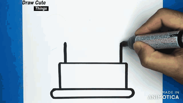 a person is drawing a birthday cake on a piece of paper with the words draw cute things above it