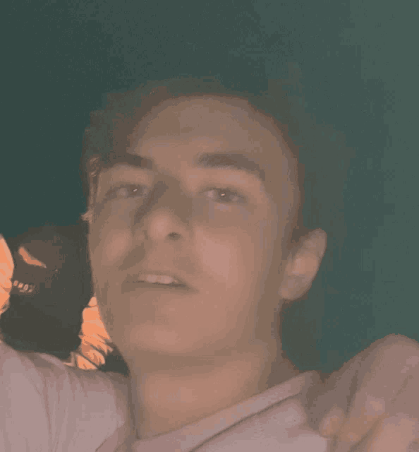 a close up of a man 's face with a blurred background that says ' sds ' on it