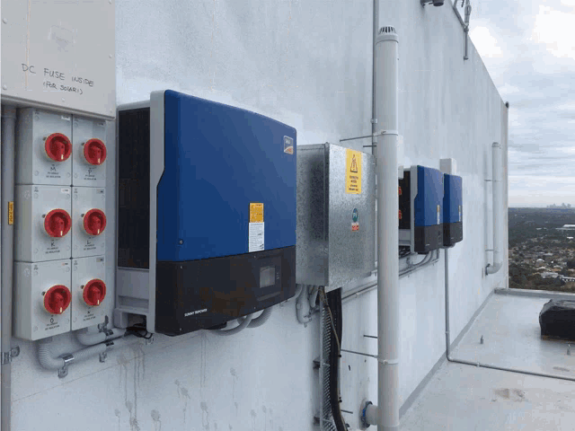 a row of solar panels on a building with a box that says dc fuse wiring