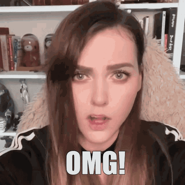 a woman with a surprised look on her face and the word omg written on her face