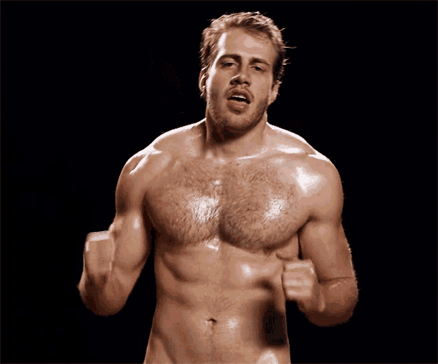 a shirtless man is giving a thumbs up in front of a black background