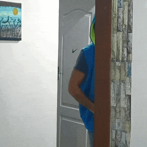 a man in a blue vest is standing in front of a door that has a nike logo on it
