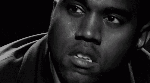 a black and white photo of a man 's face with tears coming down his face .