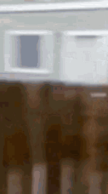 a blurry picture of a table and chairs in a room .