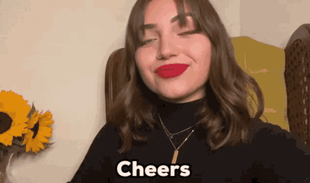 a woman with red lipstick and the word cheers behind her
