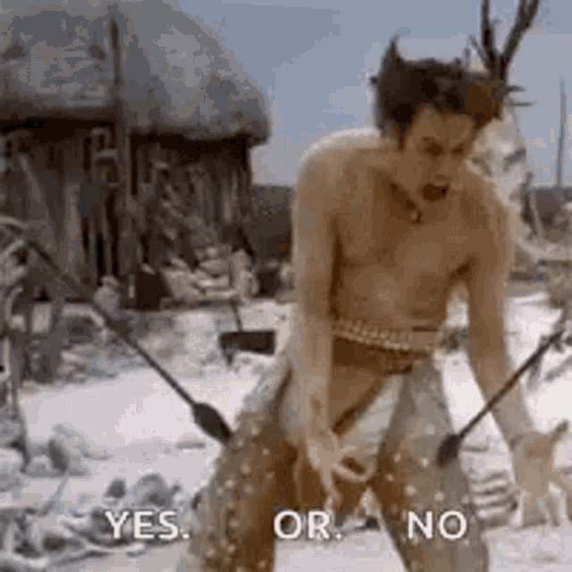 a man without a shirt is standing in the snow holding a sword and saying yes or no .