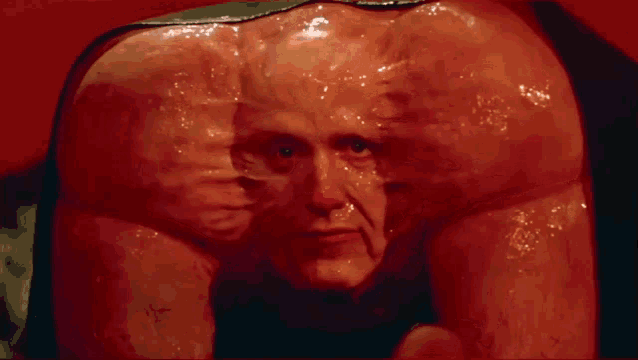 a close up of a man 's face with a large stomach