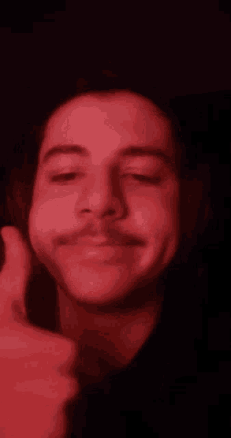 a close up of a man 's face with a red background