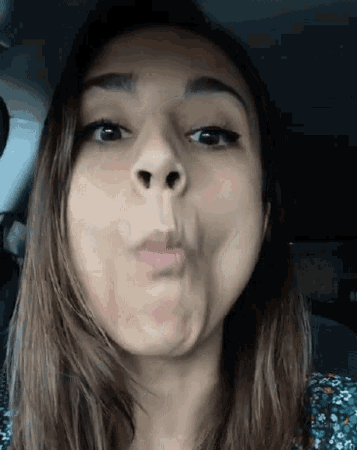 a close up of a woman making a face