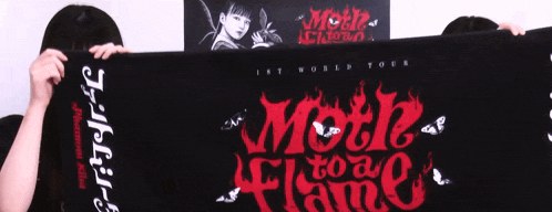 a woman is holding a black towel that says " motif to flame "
