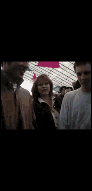 a group of people are standing in a tent and one of them is smiling