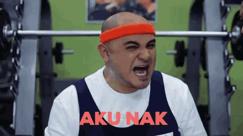 a man wearing an orange headband with akunak in red