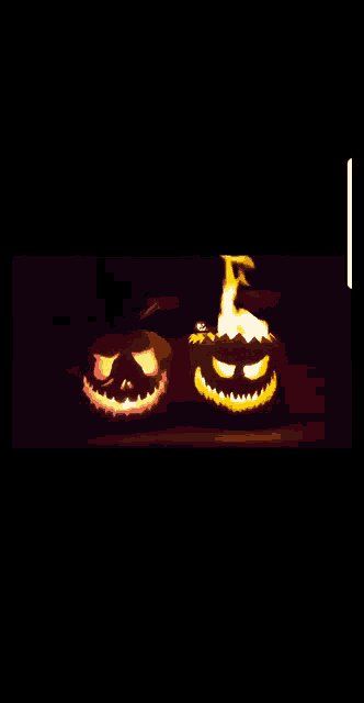 two carved pumpkins with flames coming out of their mouths