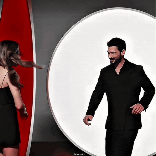 a man in a suit is standing next to a woman in a black dress in front of a large white circle