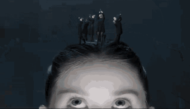 a person with a bunch of faces on their hair