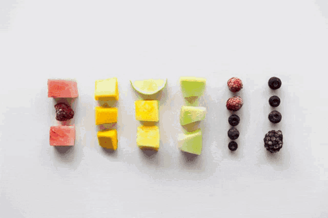 a row of different colored popsicles on sticks