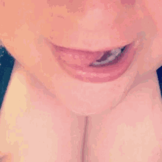 a close up of a person 's mouth with their tongue sticking out