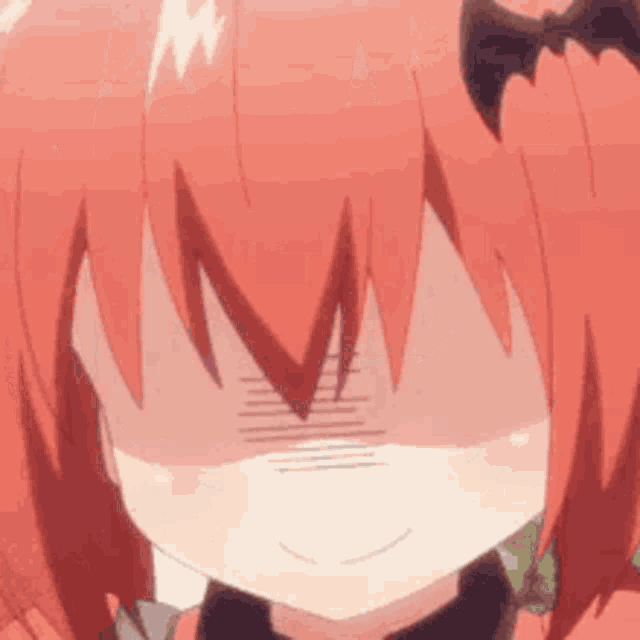 a close up of a girl with red hair covering her face with her hand .