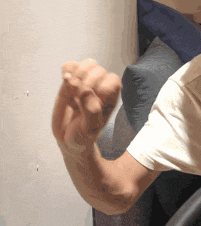 a person 's arm is shown with a white shirt on