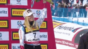 a woman stands in front of a sign that says 7 oritz on it