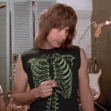 a man wearing a black shirt with a skeleton design on it