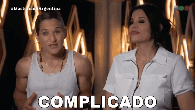 a man and a woman are standing next to each other with the word complicatado written in white