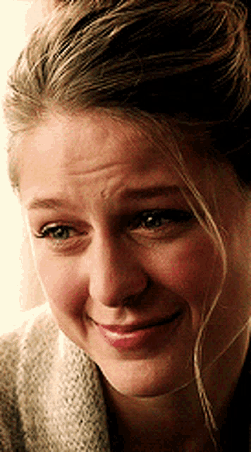 a close up of a woman 's face making a funny face