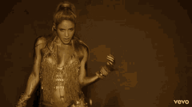 a woman is dancing in a video that says vevo on it