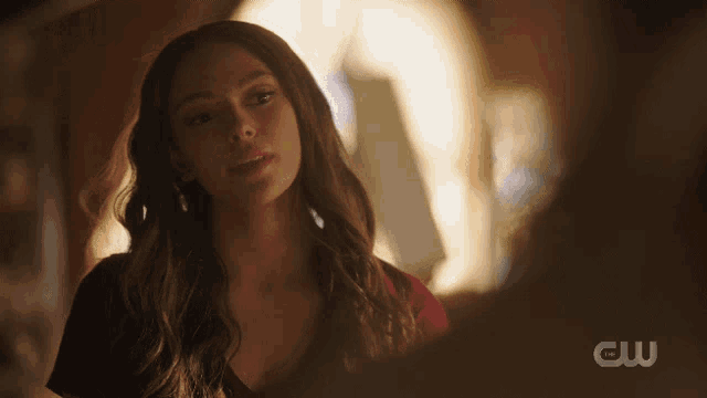 a close up of a woman 's face with the cw logo in the corner