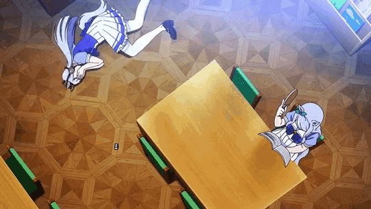a girl is laying on the floor while another girl sits at a table reading a magazine .