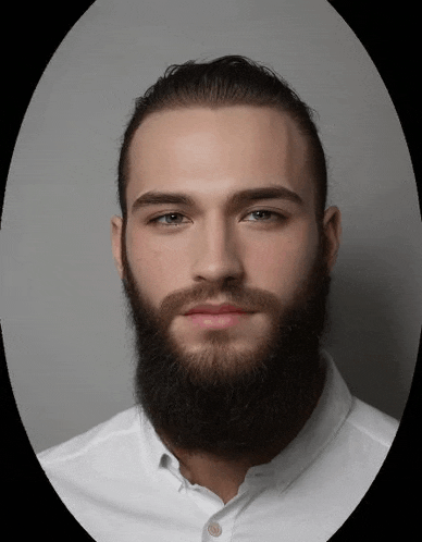 the man is wearing a white shirt and has a beard .