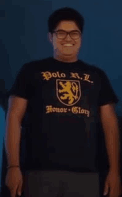 a man wearing glasses and a black polo r.l. honor glory shirt
