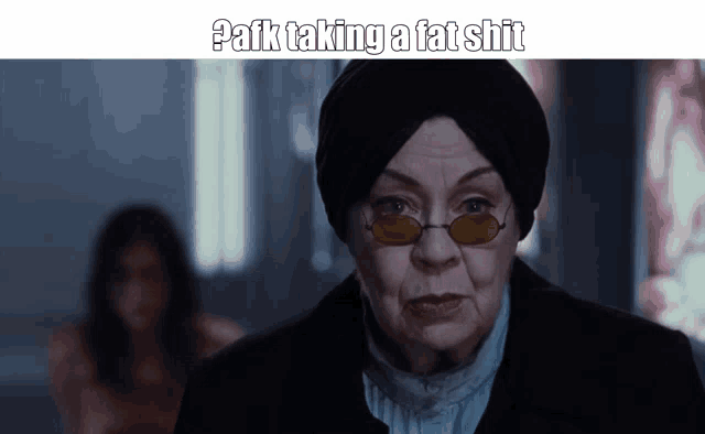 an older woman wearing glasses and a turban says " pafk taking a fat shit "