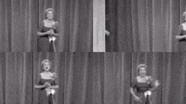 a group of people are standing on a stage in front of a curtain